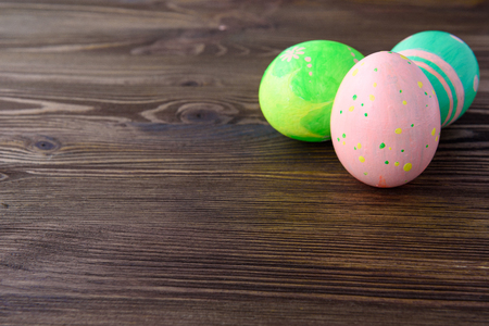 Easter eggs on wooden background, colorful, brightの写真素材