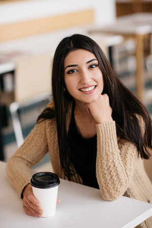 A shot of woman drinking coffee in a cafeの写真素材