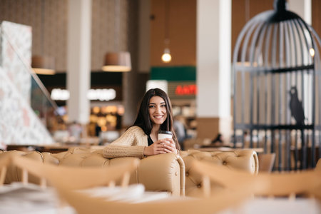A shot of woman drinking coffee in a cafeの写真素材