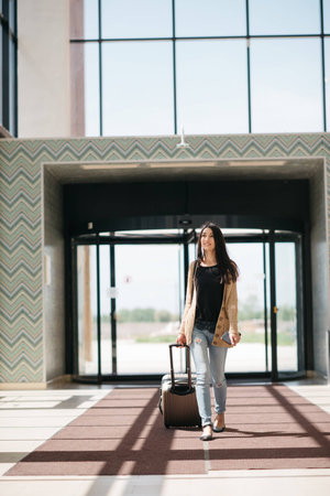 young girl with a suitcase goes on the terminalの写真素材