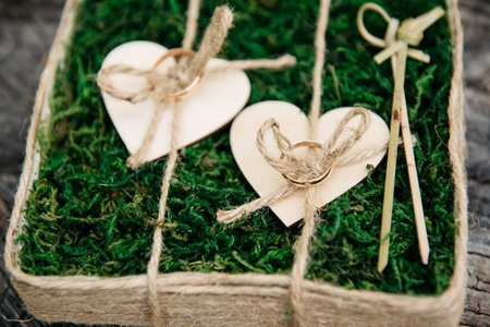 Beautiful wedding rings on wooden background, a stumpの写真素材