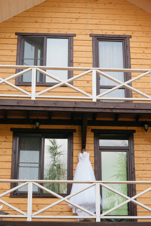 White wedding dress hanging on the balconyの写真素材