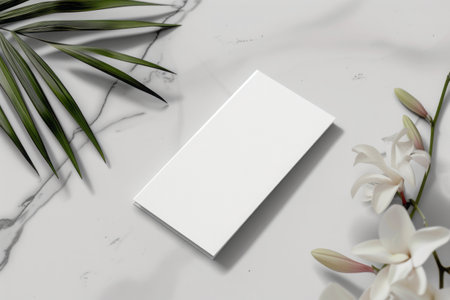 Mockup of business cardle background with palm leaf and flowersの素材