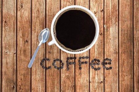 Coffee cup and coffee beans on wood table . 3D rendering