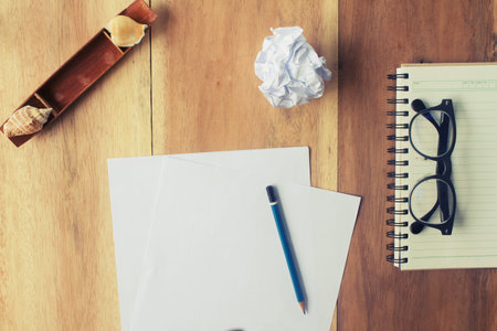 Pencil and white notebooks on wooden - tone vintageの写真素材