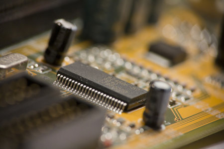 Detail of capacitor on yellow computer motherboard の写真素材