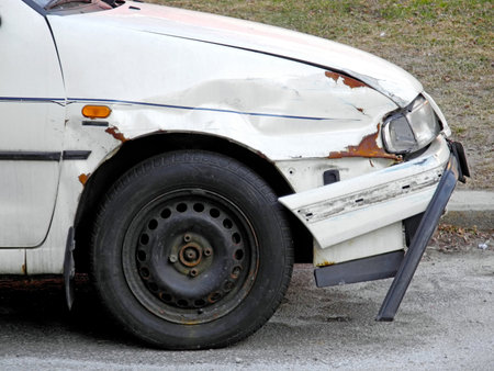 Discarded and damaged wreck of car with broken bumper                          の写真素材