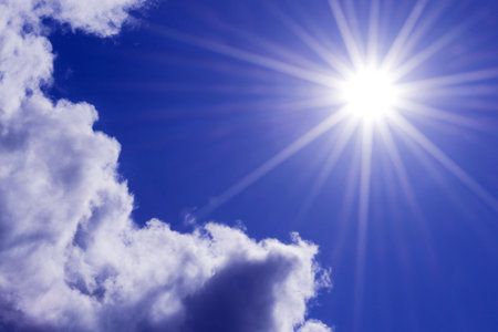 Sun rays with white clouds in the summer afternoon skyの写真素材