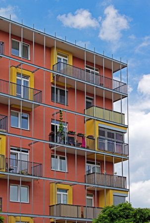 Modern apartments with balconies and red wallsの写真素材