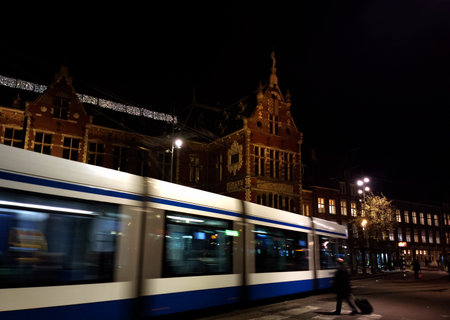 Blue tram in Amsterdam, Netherlands in front of the train stationの写真素材