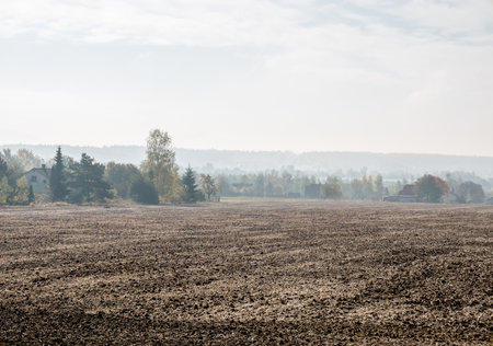 Smog in a small village with a brown fieldの写真素材