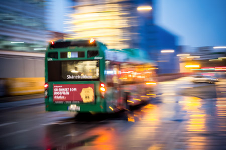 MALMO, SWEDEN - OCTOBER 25: Fast driving green bus in the Malmo city at night in Sweden on October 25, 2014.のeditorial素材