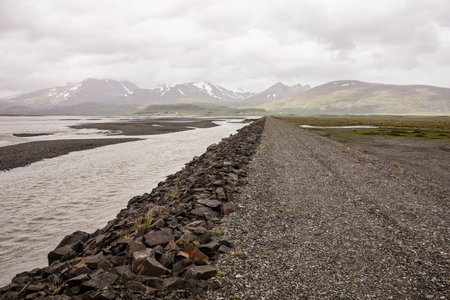 Gravel road near the river and ocean in Stafafell area in Icelandの写真素材