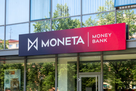 OSTRAVA, CZECH REPUBLIC - MAY 5, 2018: Logo of the Moneta Money Bank above the entrance with reflection of trees in the windows. The image was taken in Ostrava-Poruba, Czech Republic on May 5, 2018.のeditorial素材