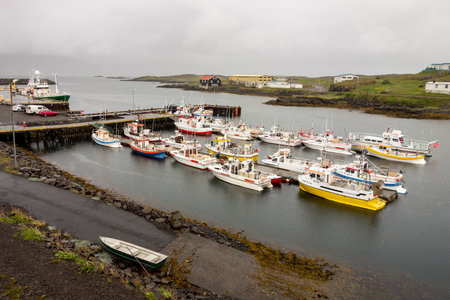 DJUPIVOGUR, ICELAND - JULY 2, 2014: A small harbour in a city of Djupivogur, Iceland with a lot of small ships during overcast weather. The image was taken on July 2, 2014.のeditorial素材