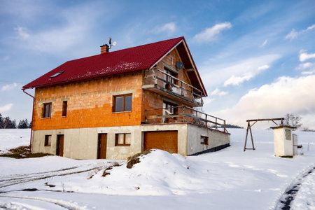 Unfinished house under construction during winter with snow landscapeの写真素材