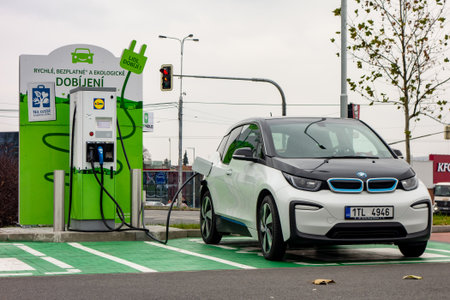 OSTRAVA, CZECH REPUBLIC - NOVEMBER 27, 2018: BMW i3 electric car is charged on a green parking space next to the Lidl shopping mall in Ostrava providing this free service to its customers.のeditorial素材