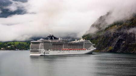 NORWAY - AUGUST 12, 2016: MSC Splendida cruise ship in a fjord in Norway during overcast weather visiting famous cities in the country and overseas.のeditorial素材