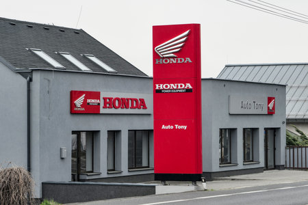 SENOV, CZECH REPUBLIC - APRIL 12, 2019: The Honda dealership with red colour and a logo in Senov, Czech Republic. The company sells motorcycles and garden equipment.のeditorial素材