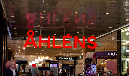 STOCKHOLM, SWEDEN - APRIL 20, 2019: The red logo above the entrance to Ahlens shopping mall and store with full of clothing and other shopsのeditorial素材