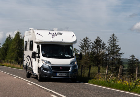 ISLE OF SKYE, GREAT BRITAIN - AUGUST 3, 2019: Fiat Ducato caravan of the Motorhome Hire company on Scottish    roads travelling for a next adventure.のeditorial素材