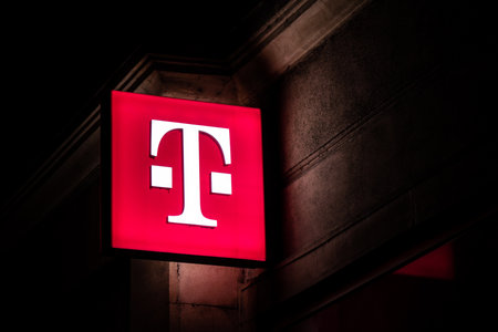 HAVIROV, CZECH REPUBLIC - OCTOBER 24, 2019: The glowing logo of the T-Mobile telecommunication company providing 4G and 5G connection at night above on of its shops in Havirovのeditorial素材