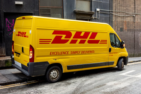 GLASGOW, SCOTLAND - JULY 31, 2019: Damaged yellow van of the DHL logistics company with scratches...