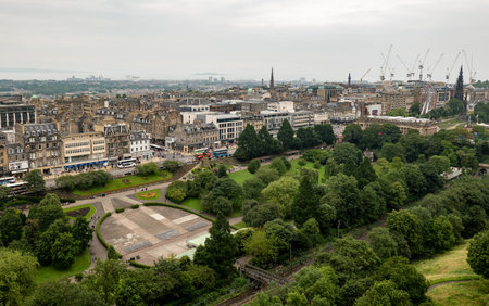 EDINBURGH, SCOTLAND - JULY 29, 2019: The top view at West Princes Street Gardens park from Edinburgh Castle with public transportation at the main streetのeditorial素材