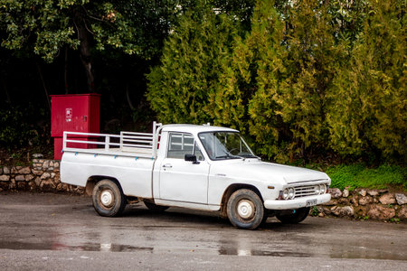 DELPHI, GREECE - FEBRUARY 6, 2019: The old legendary vintage Mazda B1600 pickup parked on a wet road in front of trees in Greece where these Japanese vehicles are very popularのeditorial素材