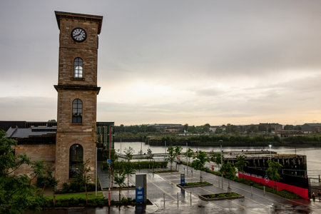 GLASGOW, SCOTLAND - JULY 31, 2019: The tower and historical building of the Clydeside Distilery in Glasgow with wet roads after rain.のeditorial素材