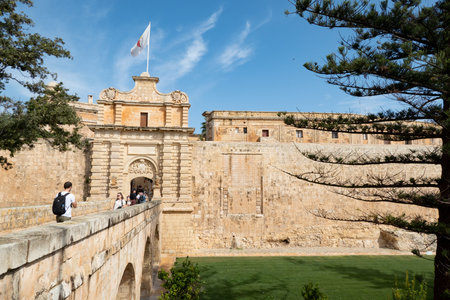 MDINA, MALTA - OCTOBER 2018: Bridge and Mdina Gate to the historical complex of buildings ner...