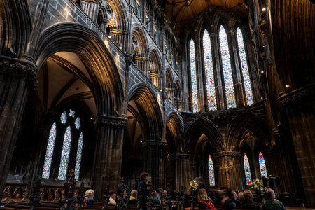 GLASGOW, SCOTLAND - JULY 31, 2019: Inside Glasgow Cathedral, also knows as High Kirk of Glasgow, St Kentigerns or St Mungos Cathedral. Tourists are listening to the guideのeditorial素材