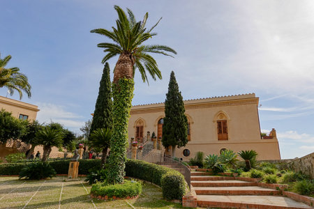 AGRIGENTO, SICILY - FEBRUARY 10, 2020: Building of Villa Aurea located in Valley of the Temples (Valle dei Templi) with palms and blue skyのeditorial素材