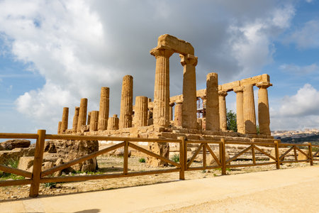 Temple of Juno (Tempio di Giunone) in Valley of the Temples (Valle dei Templi) near Agrigento, Sicily, Italy behind the wooden fenceの写真素材