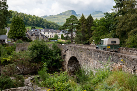 KILLIN, SCOTLAND - AUGUST 2, 2019: The historical stone bridge of the A827 road above the river and...