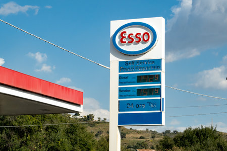 SICILY - FEBRUARY 14, 2020: The logo of Esso self service gas station on a white banner where the gasoline and diesel fuels are sold at given priceのeditorial素材
