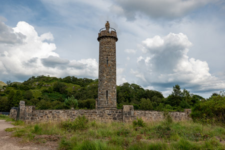 Glenfinnan Monument from beginning of the 19th century with a statue of anonymous highlander in Scotland, UKのeditorial素材
