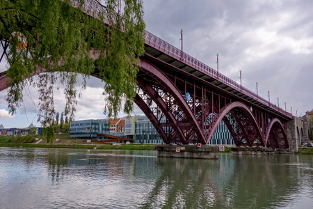MARIBOR, SLOVENIA - APRIL 16, 2014: Historical purple main bridge (Glavni most) over the Drava river...