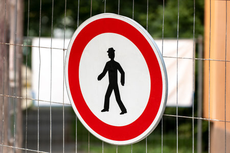 Red round traffic sign forbidding the entry for pedestrians to the industrial construction siteの写真素材