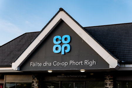 PORTREE, SCOTLAND - AUGUST 5, 2019: The logo of COOP international grocery shop chain above an...