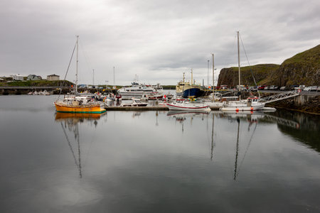 STYKKISHOLMUR, ICELAND - JULY 9, 2014: Harbour with ships and vessels in Stykkisholmur city on the...
