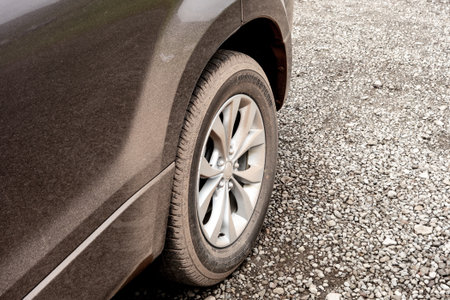 ICELAND - JULY 8, 2014: Bridgestone rear tyre on a dirty SUV after muddy road of Iceland were...
