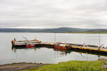 HOLMAVIK, ICELAND - JULY 7, 2014: The harbour in Holmavik city in Iceland with rusty boatsのeditorial素材