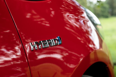 BANCHORY, SCOTLAND - AUGUST 10, 2019: The HYBRID logo on a red Toyota Yaris Hybrid small city car which has the ecological type of propulsionのeditorial素材
