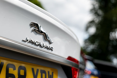 SCOTLAND - AUGUST 12, 2019: Badge of the Jaguar automotive company on a rear part of white Jaguar sedan carのeditorial素材