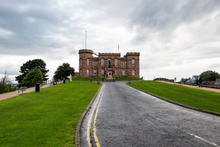 INVERNESS, SCOTLAND - AUGUST 7, 2019: Old Inverness Castle in Scotland with Floar MacDonald statue in cloudy summer dayのeditorial素材