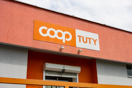 HAVIROV, CZECH REPUBLIC - JUNE 25, 2020: The entrance to Coop Tuty grocery shop with orange colour schemeのeditorial素材