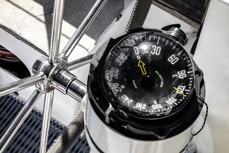 DENHAM, AUSTRALIA - JULY 5, 2018: Detail of Plastimo compass on a white yacht to control the ship and get correct directions for navigationのeditorial素材
