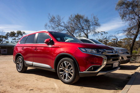 HYDEN, WESTERN AUSTRALIA - JULY 1, 2018: Red Mitsubishi Outlander SUV with chrome in outback in...