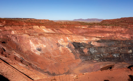 Active deep pit of red iron ore mine in Pilbara region in Western Australia